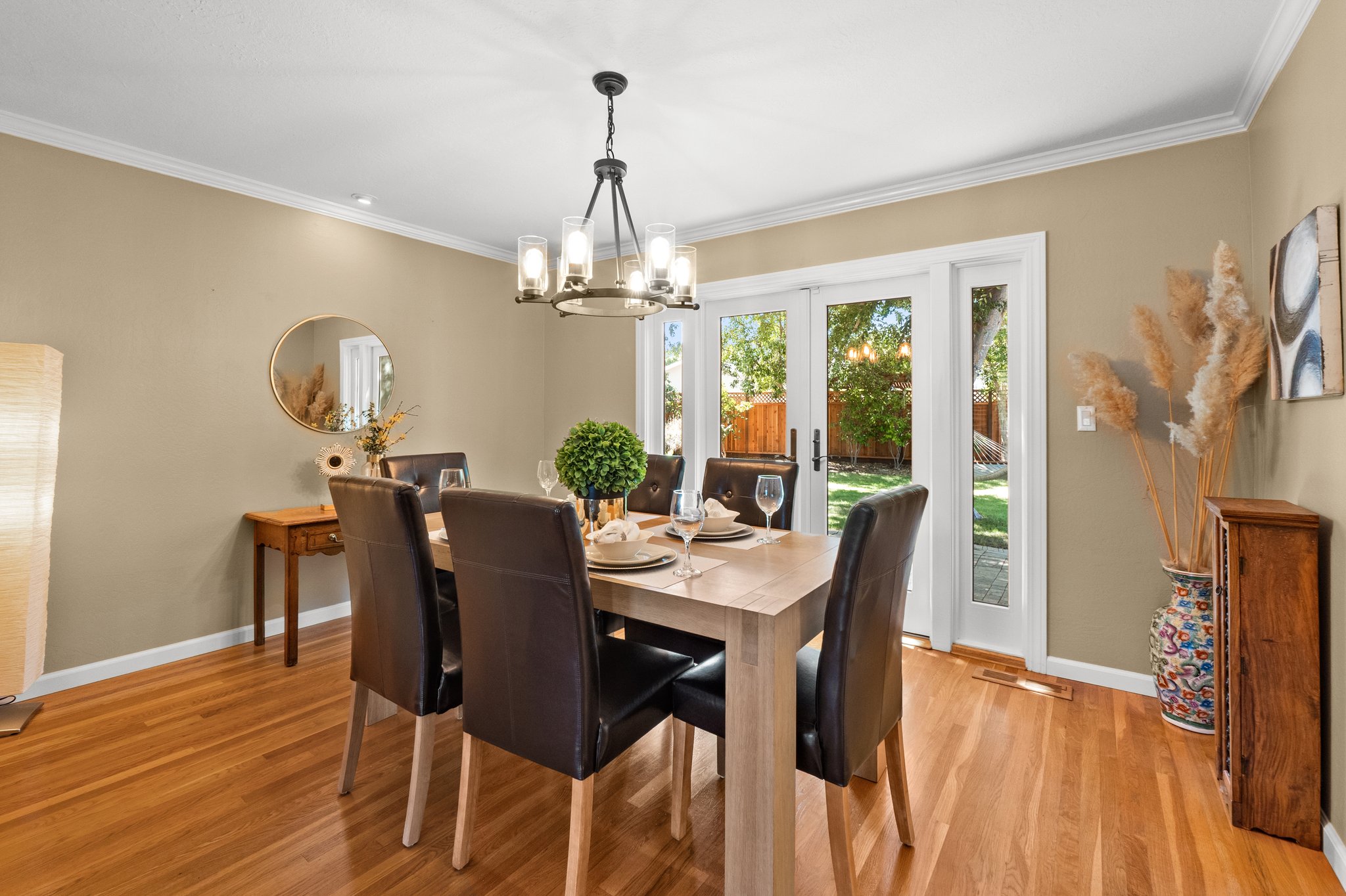 A sophisticated dining area adorned with a wooden table and chairs.