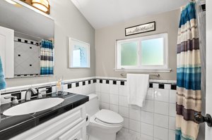 A stylish bathroom featuring a toilet and an elegantly designed washbasin.