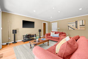 A serene living space appointed with a comfortable couch, television, and a stylish coffee table.