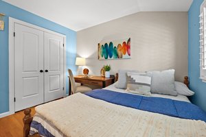 A tastefully appointed bedroom complete with an elegant bed and a sleek desk.