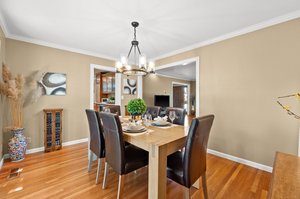A stylish dining room with a wooden table and chair ensemble.