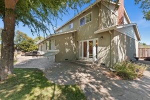 A sophisticated residence boasting a meticulously designed and expansive backyard.
