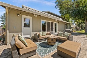 A lavish patio complete with a high-end fire pit and comfortable yet elegant seating.