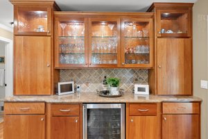 Impeccable built-in cabinetry complemented by a wine bar.