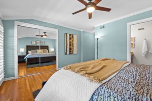 A tastefully appointed Master's bedroom complete with a lavish bed and a ceiling fan for a gentle breeze.