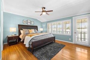 The Master bedroom, featuring an opulent bed and a ceiling fan for ultimate relaxation.