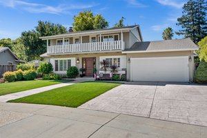 Front of House: An elegant setting featuring a spacious estate with a grand driveway and impeccably manicured lawn.