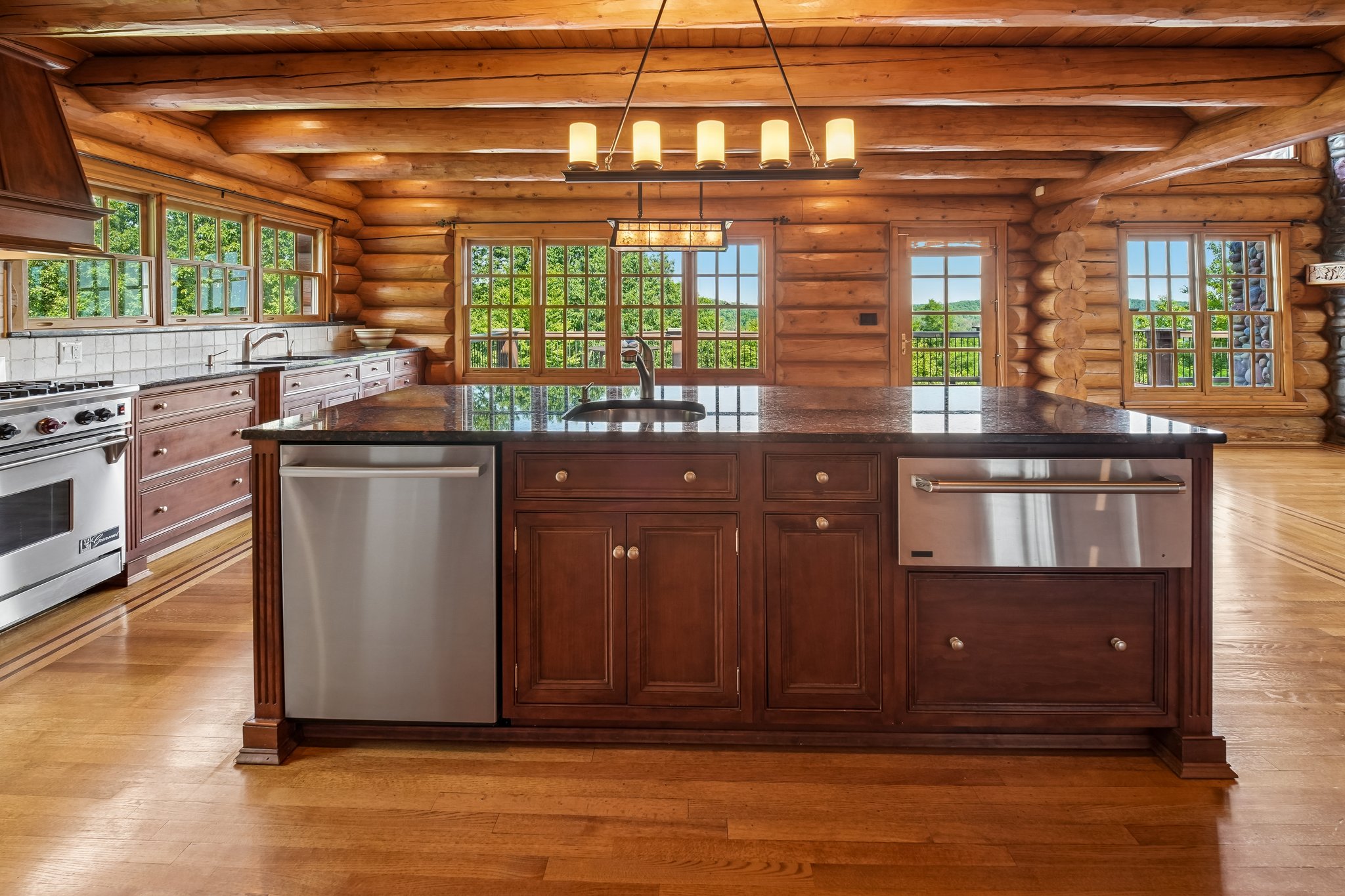 Kitchen center island features dishwasher and warming tray