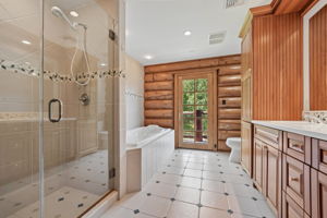 Hall full bath with jetted tub and walk in shower