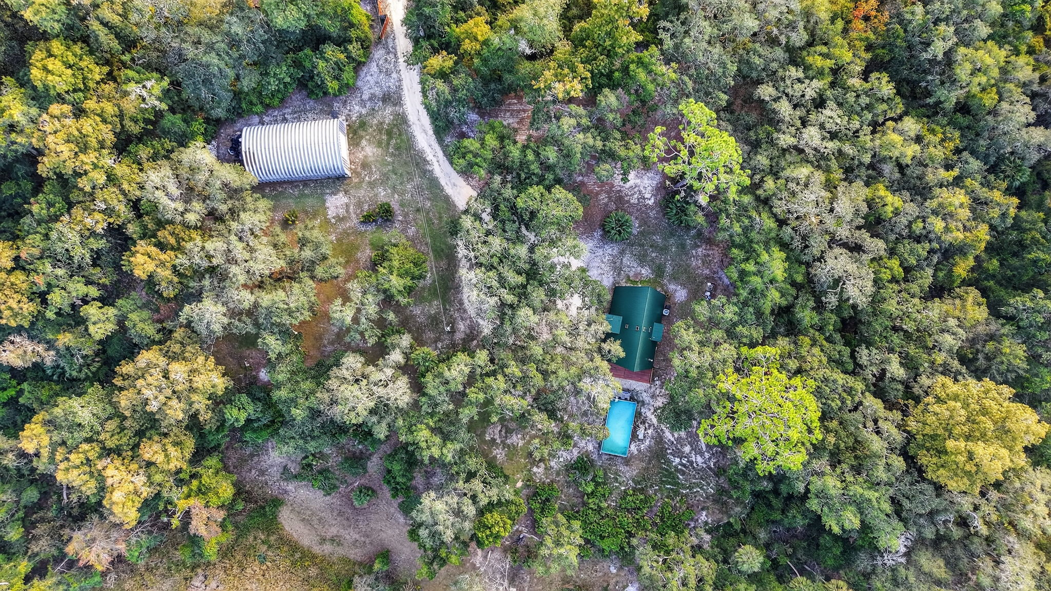 Aerial of Property with Home, Swimming Pool, and Quonset Hut/Garage