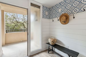 Feel the stress melt away as you are greeted by this charming entrance with crisp white shiplap and navy nautical wallpaper...