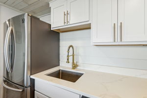 ... premium white cabinetry with brushed gold hardware ...