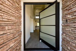 custom pivot door awaits guests