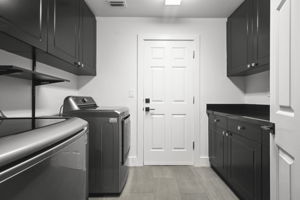 laundry room with top washer and dryer