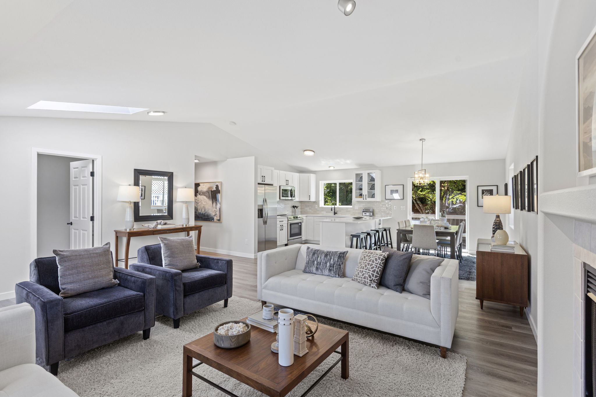 Vaulted ceilings and a skylight fill the living room with soft, natural light.