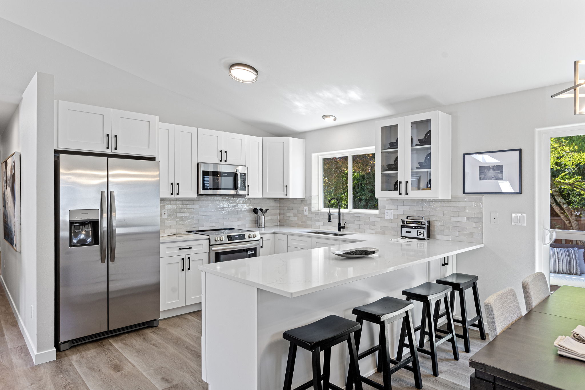 Fully remodeled kitchen with sleek quartz counters, stainless appliances, and custom cabinetry.