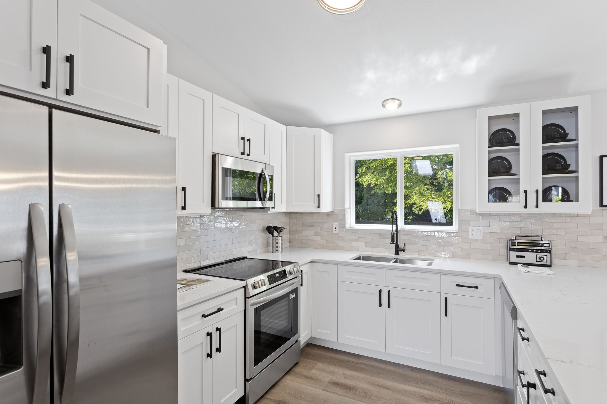 Brand-new stainless appliances, an undermount sink, and expansive counters elevate both form and function.