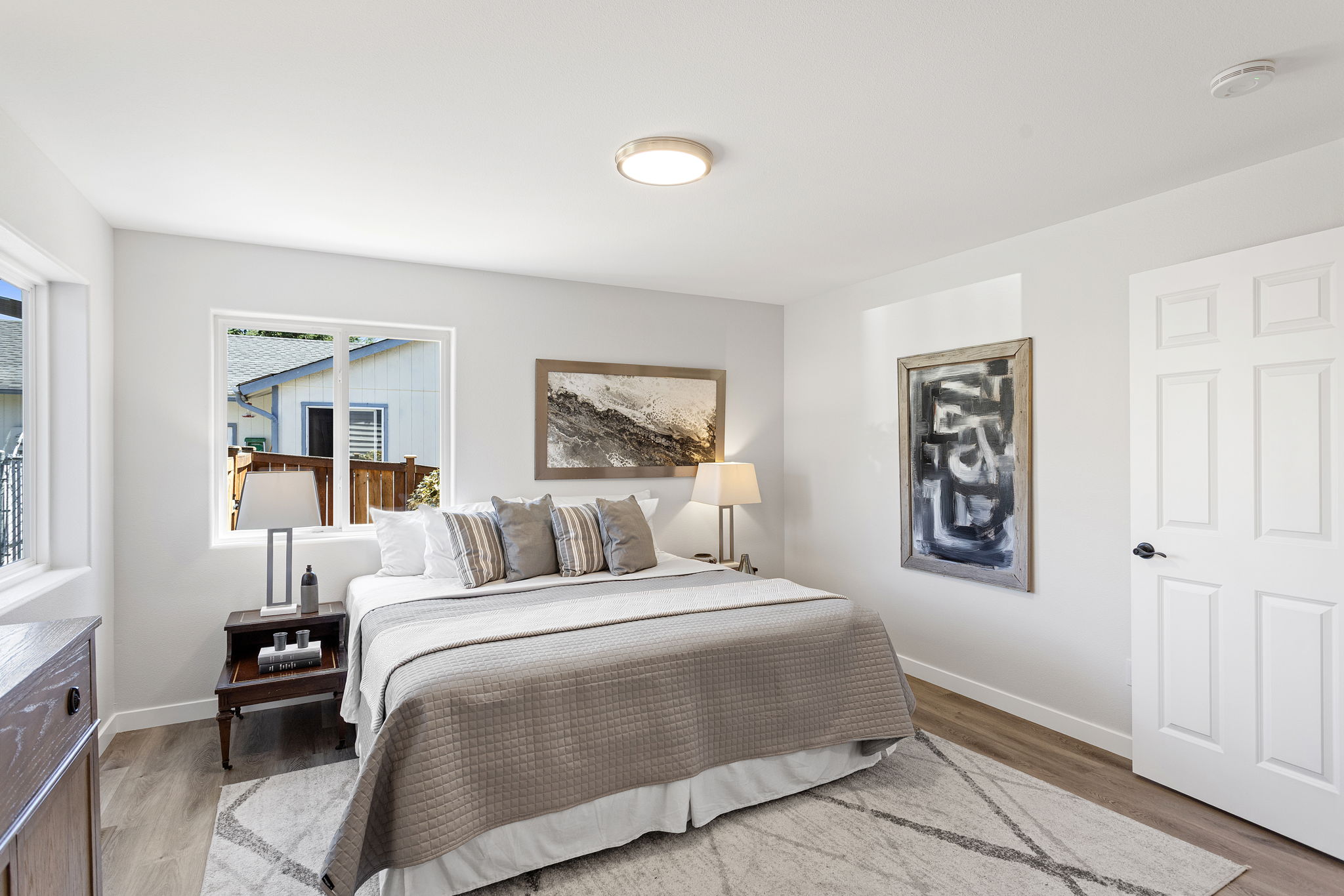 Neutral tones, updated lighting, and LVP flooring set a calm, modern tone.