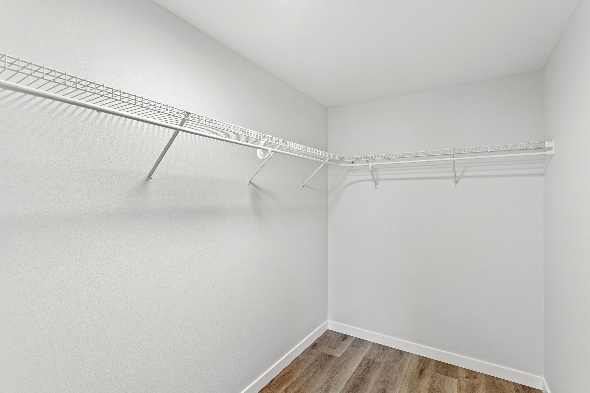 Generous walk-in closet with wraparound shelving—organized storage made simple.