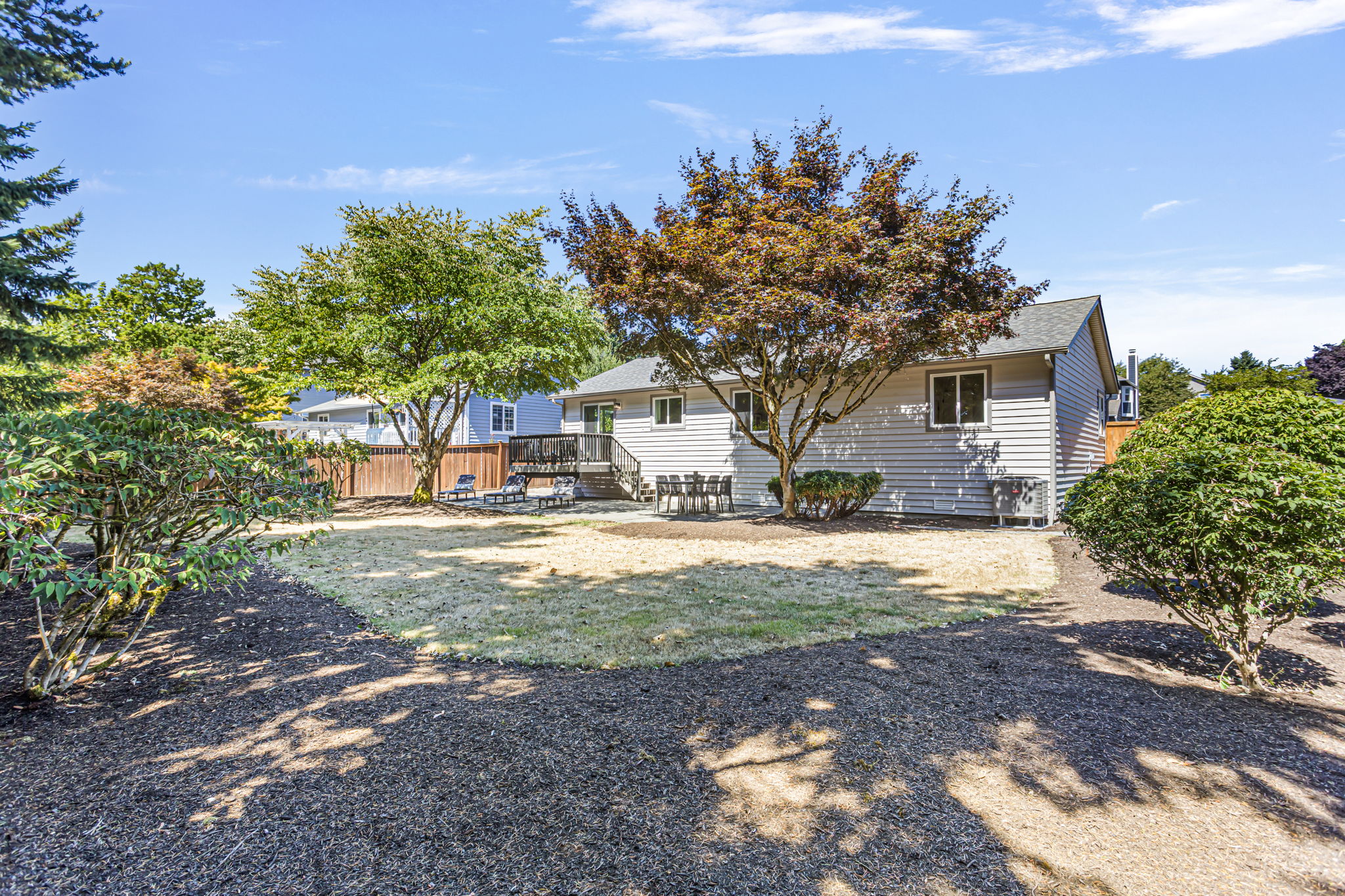 Expansive lawn and thoughtful landscaping create a welcoming backdrop.