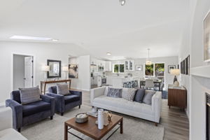 Vaulted ceilings and a skylight fill the living room with soft, natural light.