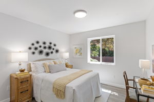 Serene bedroom with sunny yellow accents and stylish wall décor.