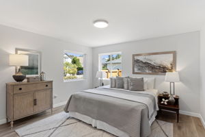 The primary suite is a serene retreat at day’s end—bathed in soft natural light from dual windows, with space for a king bed and more.