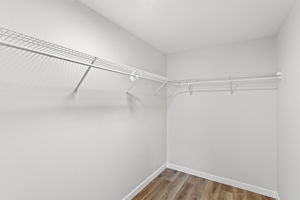 Generous walk-in closet with wraparound shelving—organized storage made simple.
