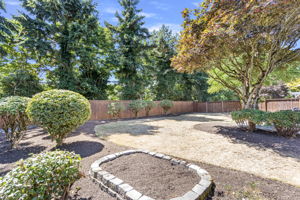 Mature trees frame the fully fenced yard for beauty and privacy.