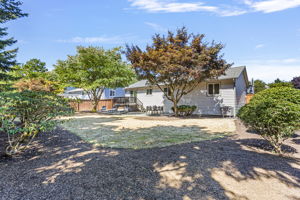 Expansive lawn and thoughtful landscaping create a welcoming backdrop.