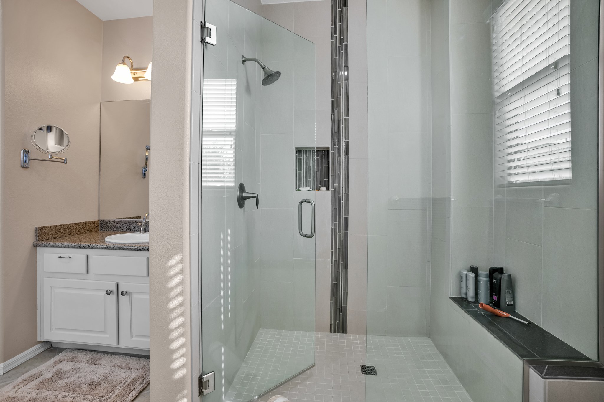 Custom tiled separate shower with sitting bench