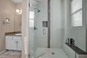 Custom tiled separate shower with sitting bench