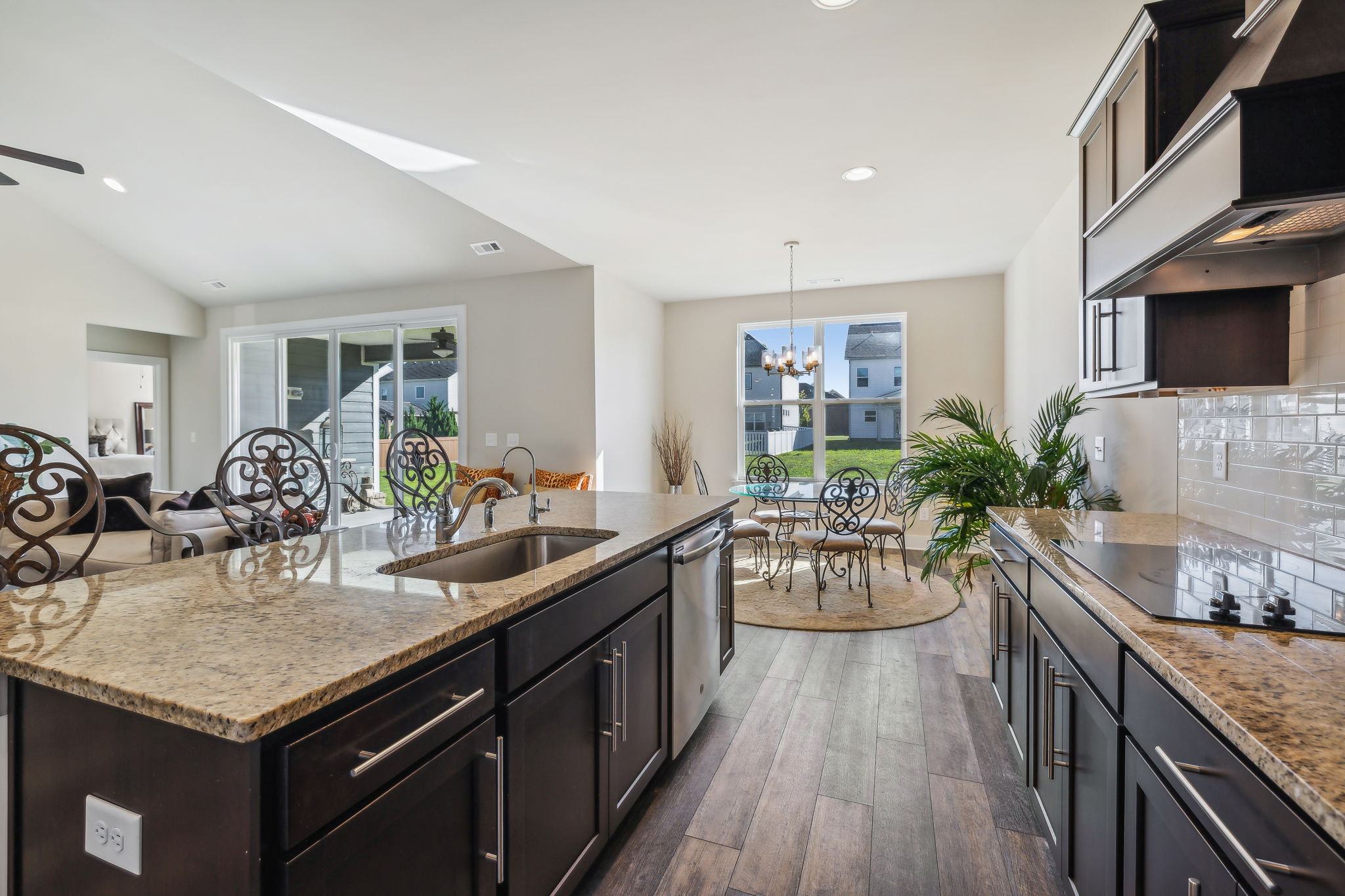 Mocha shaker cabinets with granite &  tile backsplash