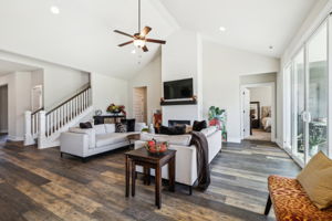 Open railing wood spindles with recessed lights and ceiling fan