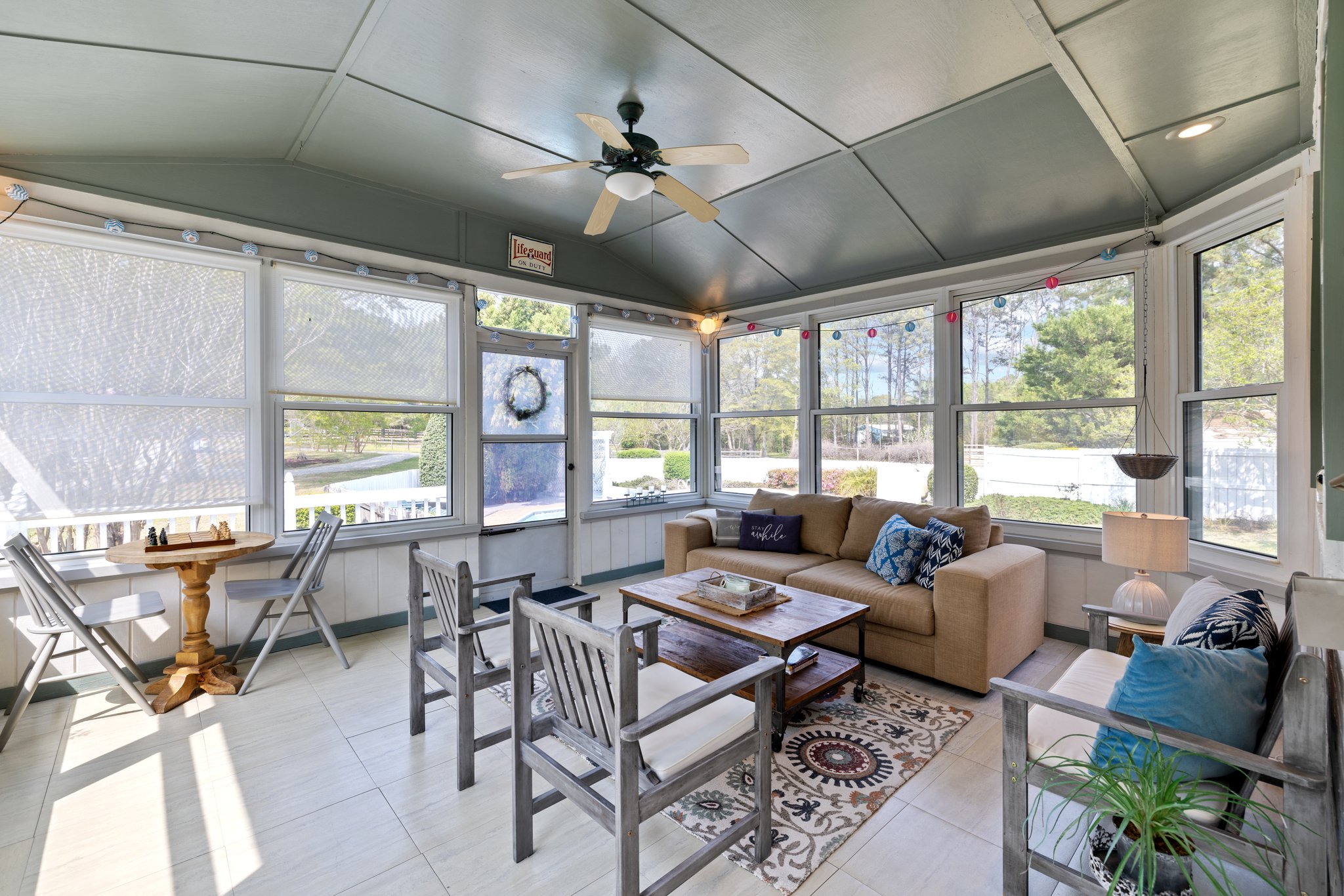 Just off the kitchen you will find this sunroom with access to the pool and backyard.