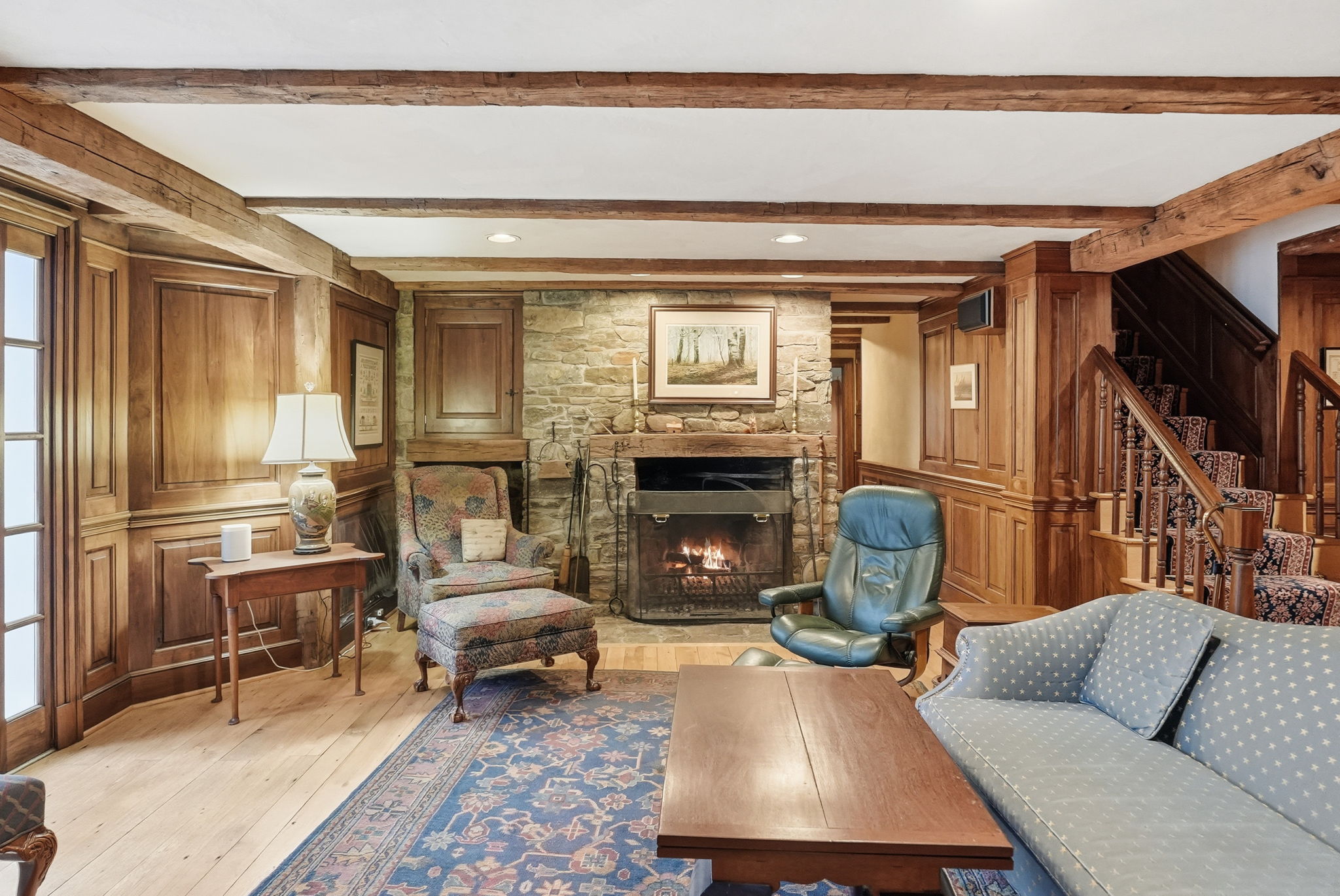 Lower level family room w/ wood burning fireplace