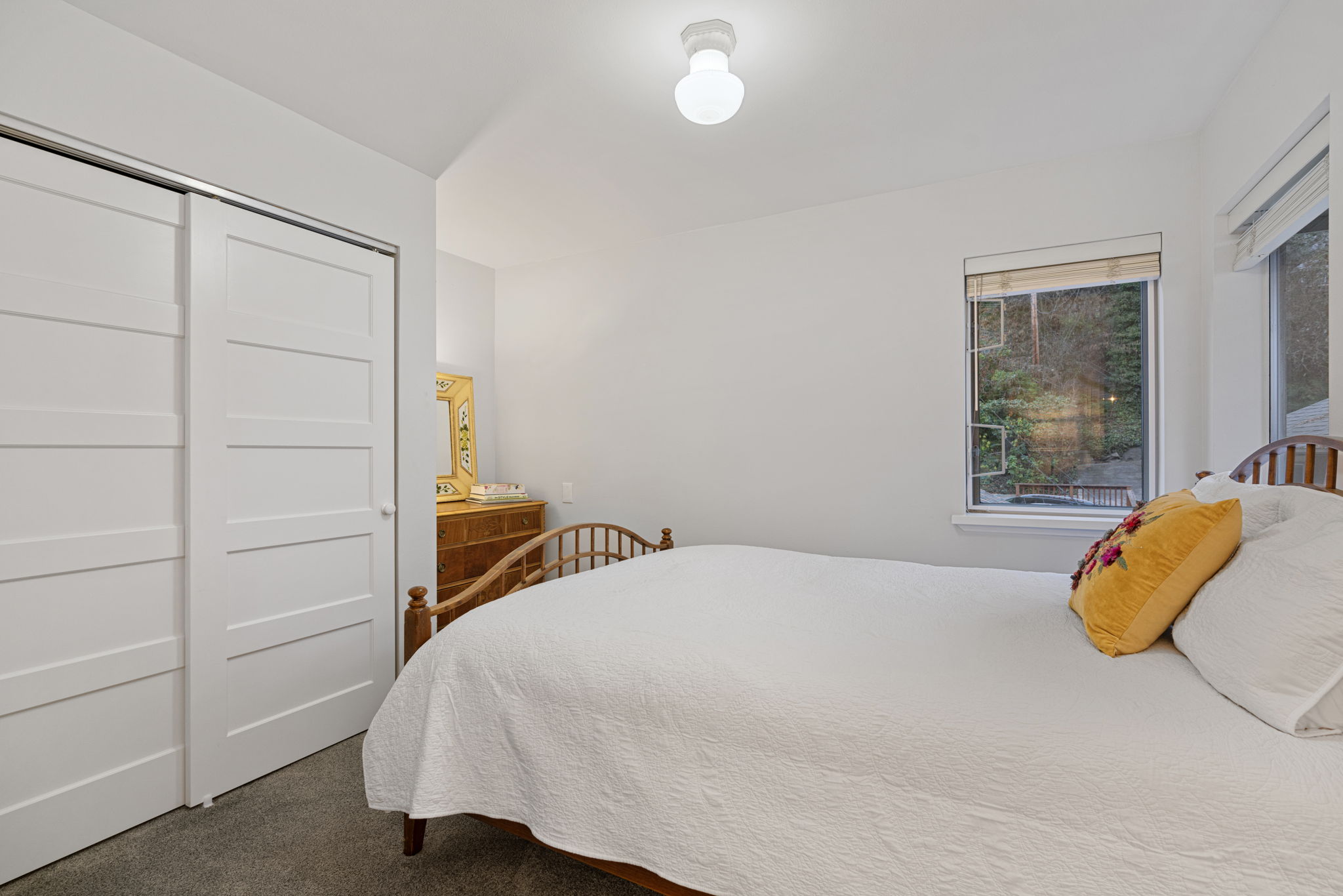 Find serenity in this bedroom with airy windows and built out closet.