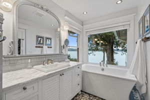 Spa-like bathroom with soaking tub and mesmerizing lake vistas.