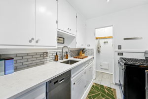 Updated kitchen with quartz countertops, backsplash, newer dishwasher and a pantry!