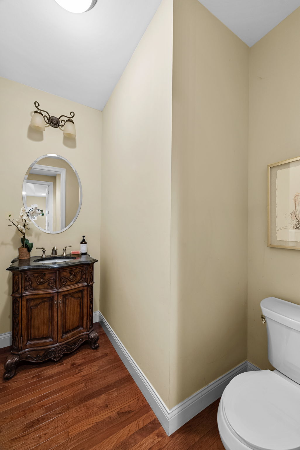 The main floor features TWO half baths for convenience. This one is just off the living room for guests.