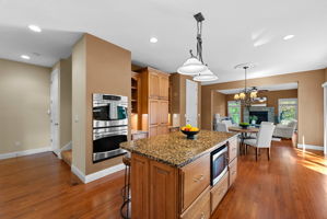 This kitchen is set up to be family central with the oversized island, dining area, and cozy attached hearth room.