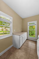 The main floor laundry/mudroom is a sizable 16x8 with a laundry sink, natural light, storage galore, appliances included, and a blank slate for your ideas!