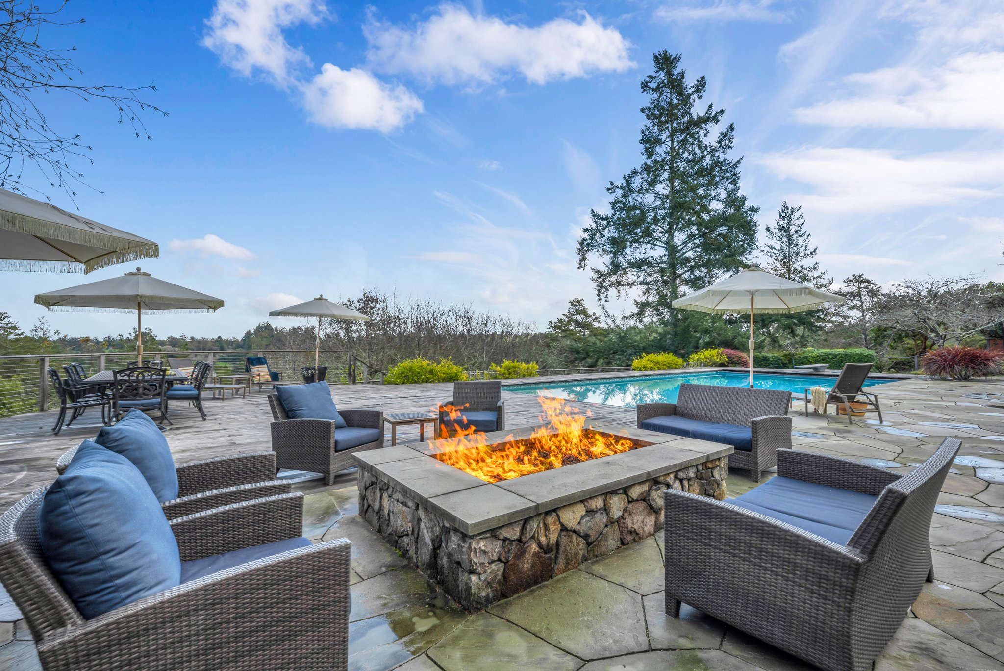 Enjoy the gas firepit next to the fully equipped covered kitchen