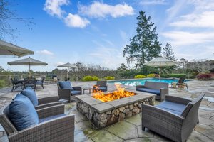 Enjoy the gas firepit next to the fully equipped covered kitchen