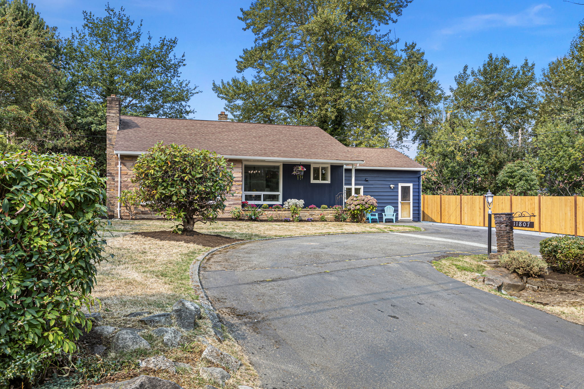Horseshoe driveway offers ample off-street parking and frames the home’s inviting front elevation.