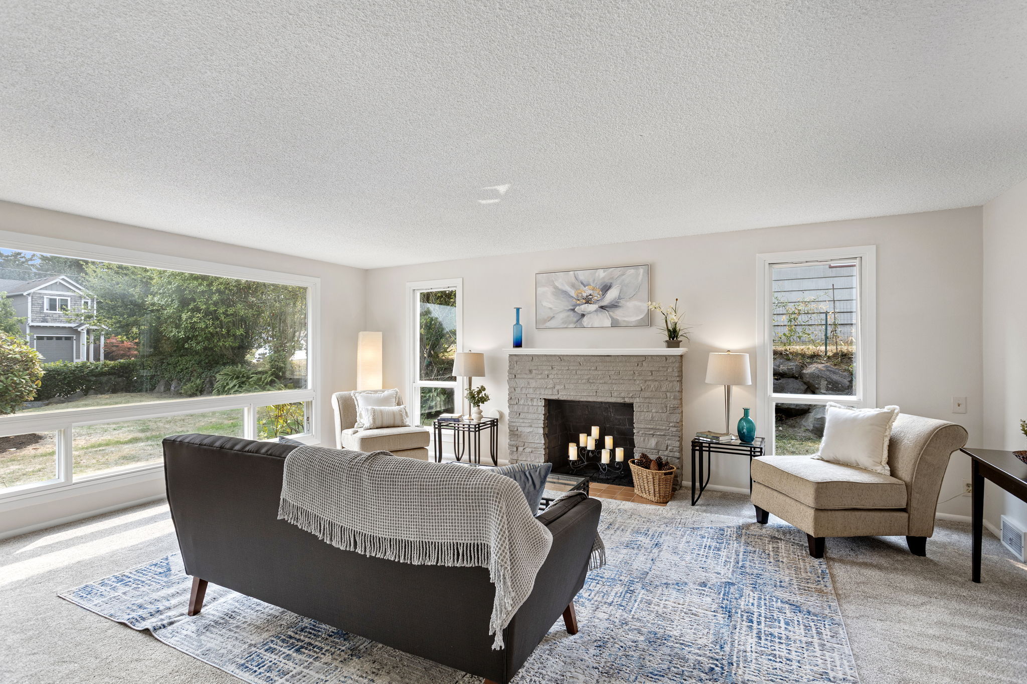 Oversized picture window anchors the room and brings in steady light from the front yard.
