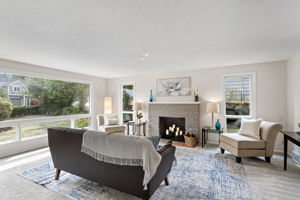 Oversized picture window anchors the room and brings in steady light from the front yard.
