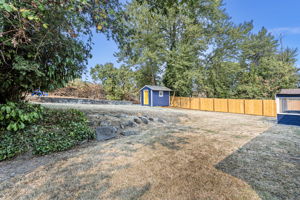 This terraced backyard combines privacy, function, and potential. A new fence spans the entire north lot line, while stonework, mature trees, and cleared upper grounds set the stage for gardening, play, or future projects. The freshly renovated shed adds charm and utility.