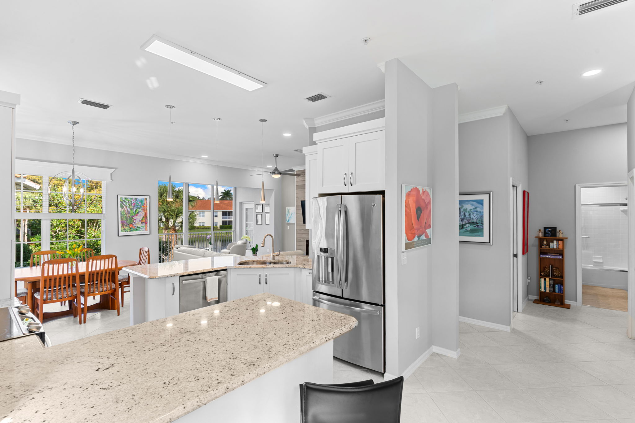 White kitchen with granite counters and excellent natural light