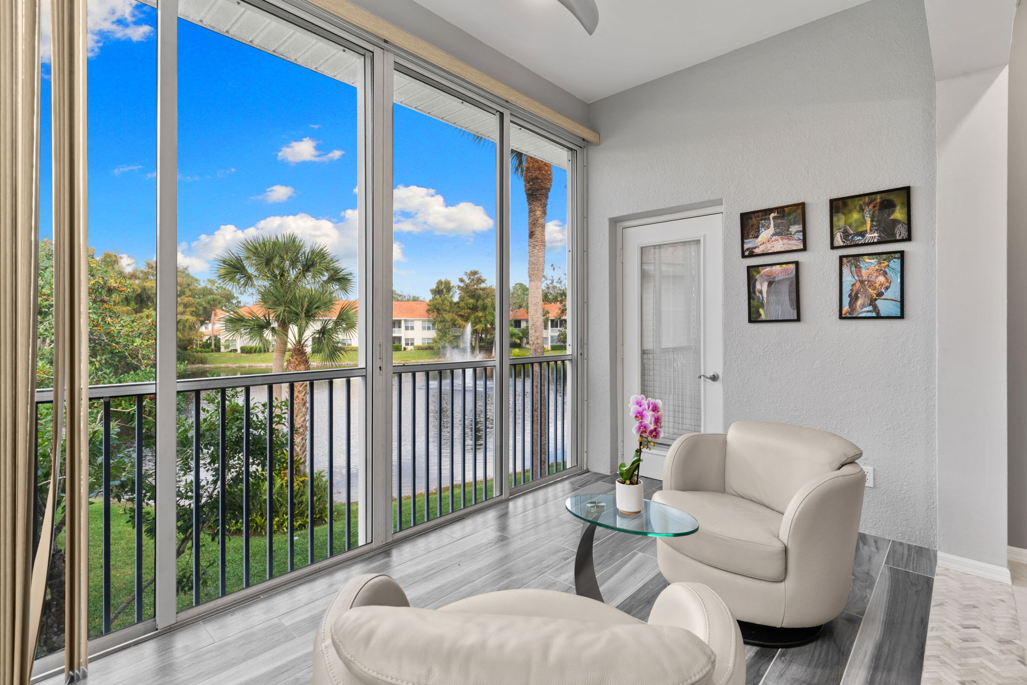 Sunlit sitting area overlooking peaceful lake and fountain views